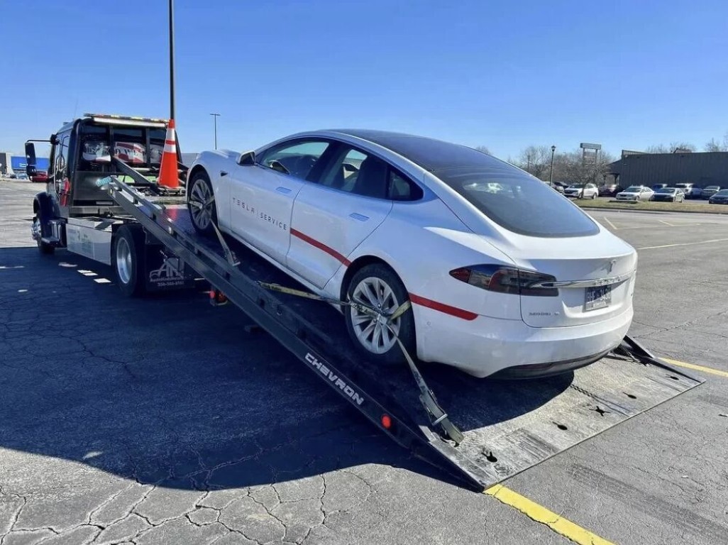 Tesla on flatbed for long distance towing from Babylon, NY