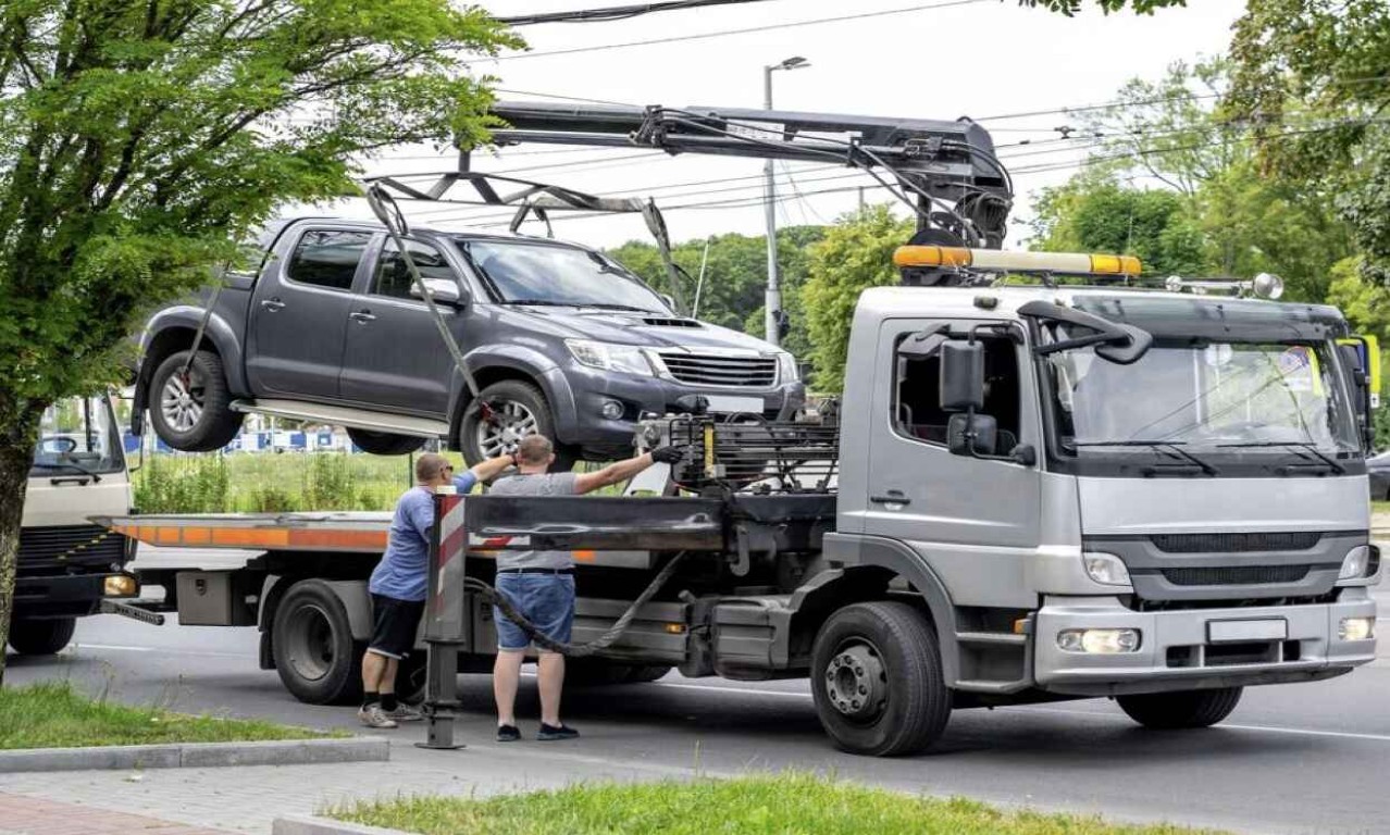 Tow truck operators providing roadside assistance to a stranded motorist in Bethpage, NY