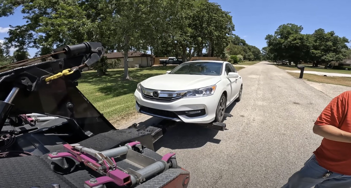 Flat tire change service on white Honda in Bethpage, NY